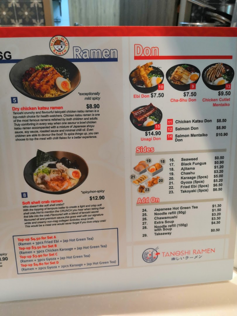 A detailed menu board for Tanoshi Ramen, featuring ramen, donburi, sides, and set meals.