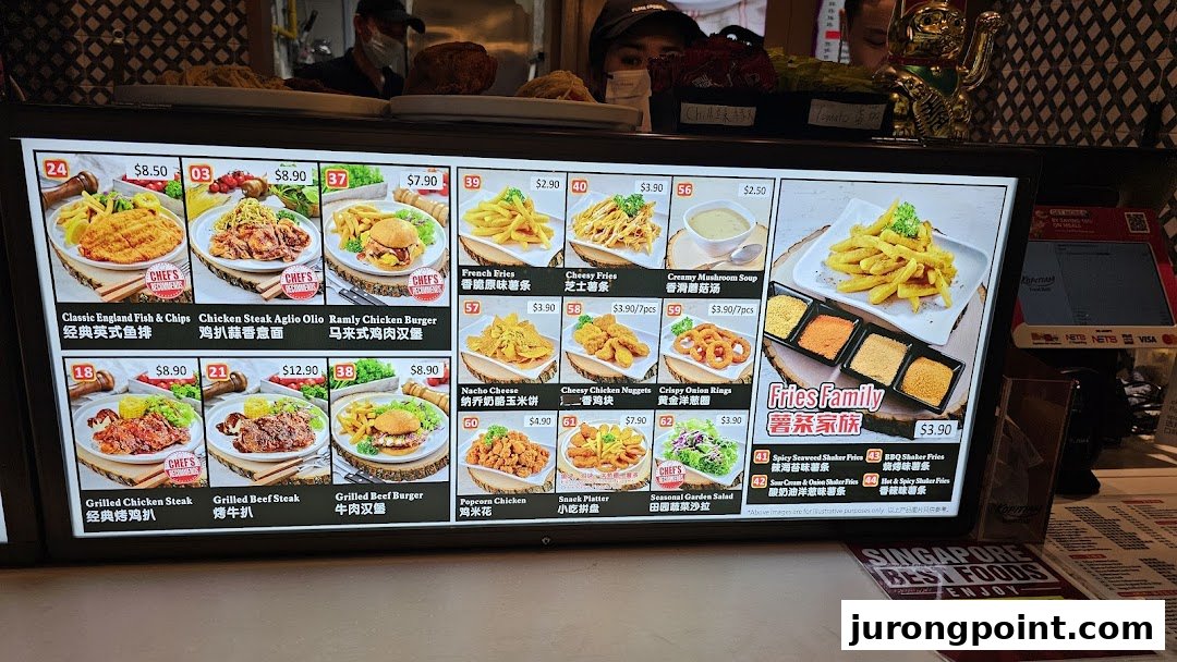 A digital menu board displaying various main courses, sides, and fries options with prices at Kopitiam Food Hall.