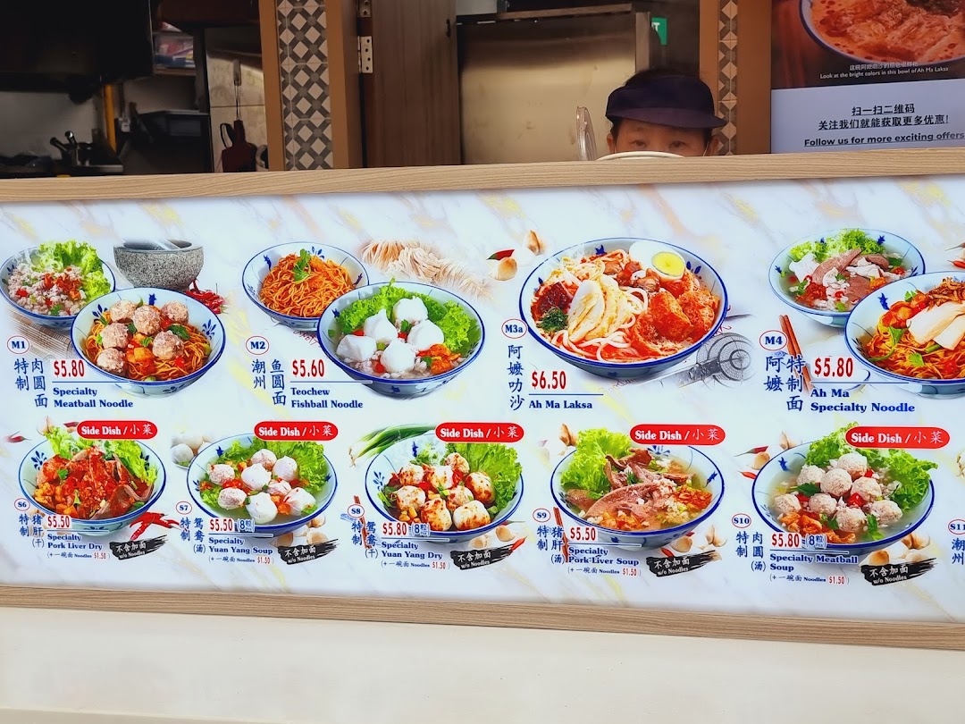 A vibrant menu board showcasing various noodle and side dishes with prices at Kopitiam Food Hall.