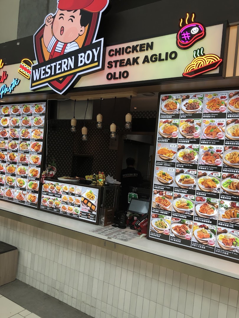 The vibrant front of Western Boy food stall, showcasing a wide array of Western dishes on illuminated menu boards.