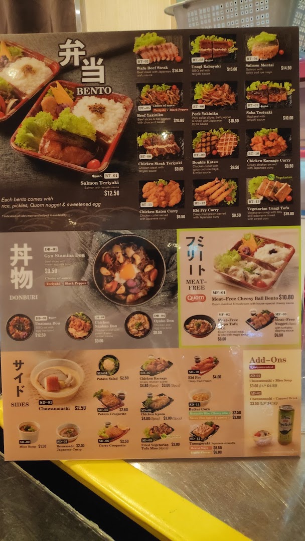 A detailed menu board displaying a variety of Japanese bento sets, donburi, meat-free options, and side dishes.