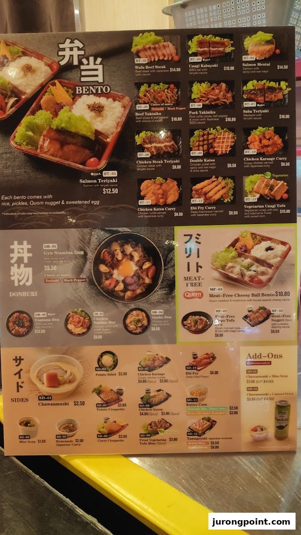 A detailed menu board displaying a variety of Japanese bento sets, donburi, meat-free options, and side dishes.