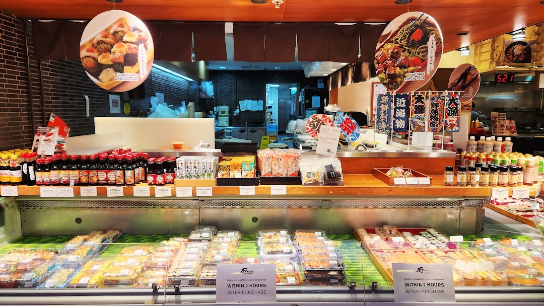 A vibrant display of fresh sushi, Japanese groceries, and sauces at Kuriya Japanese Market.