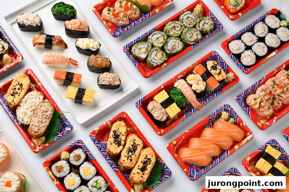A vibrant overhead view of various Japanese sushi and bento sets, ready for takeaway.