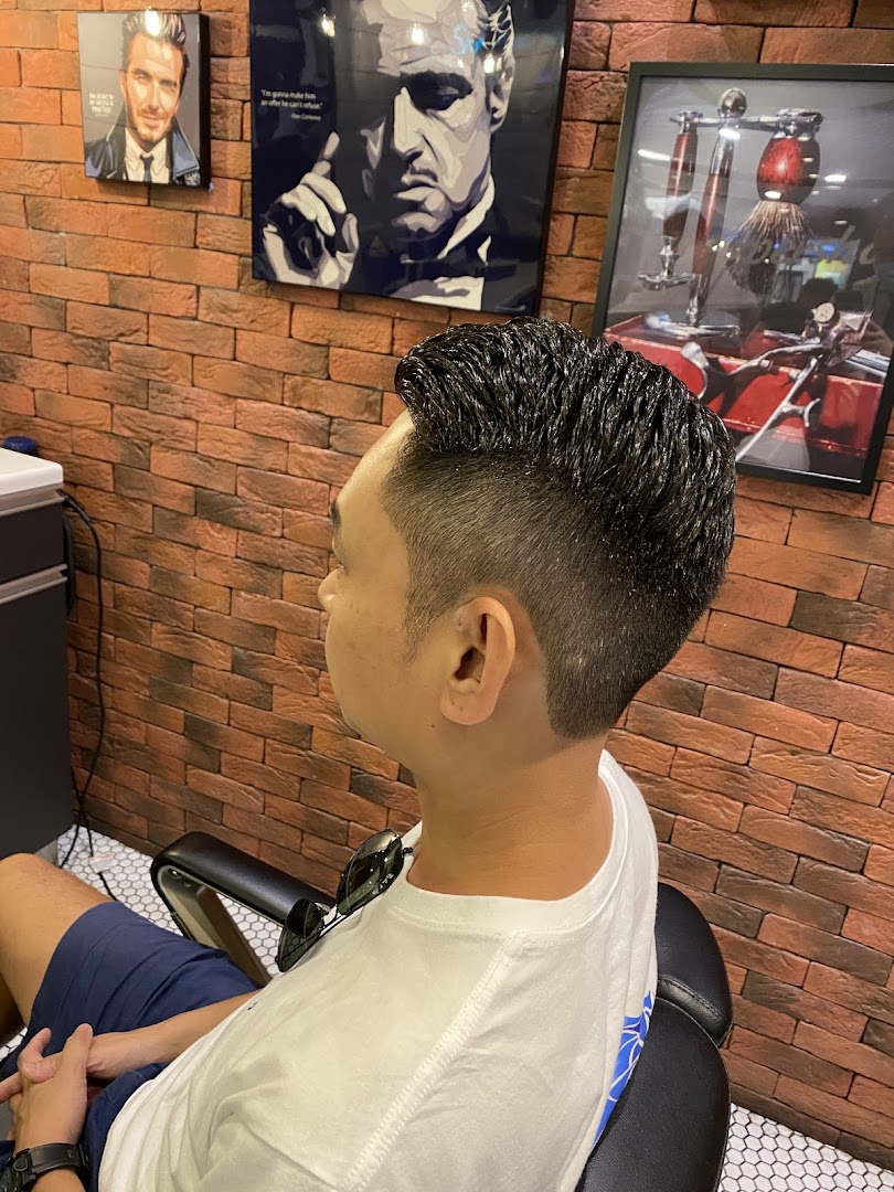 A client showcasing a fresh haircut in a modern barbershop with stylish decor.