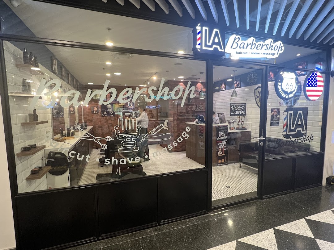 The storefront of LA Barbershop, featuring its services: hair cut, shave, and massage, with a classic American theme.