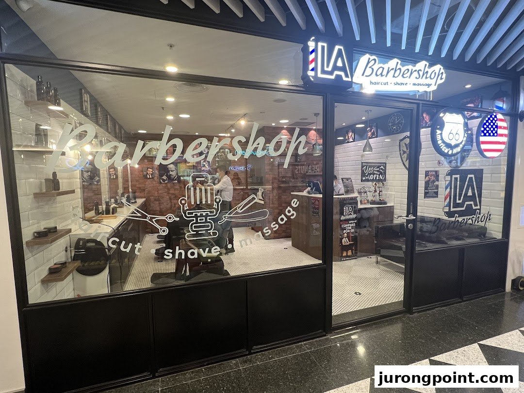 The storefront of LA Barbershop, featuring its services: hair cut, shave, and massage, with a classic American theme.