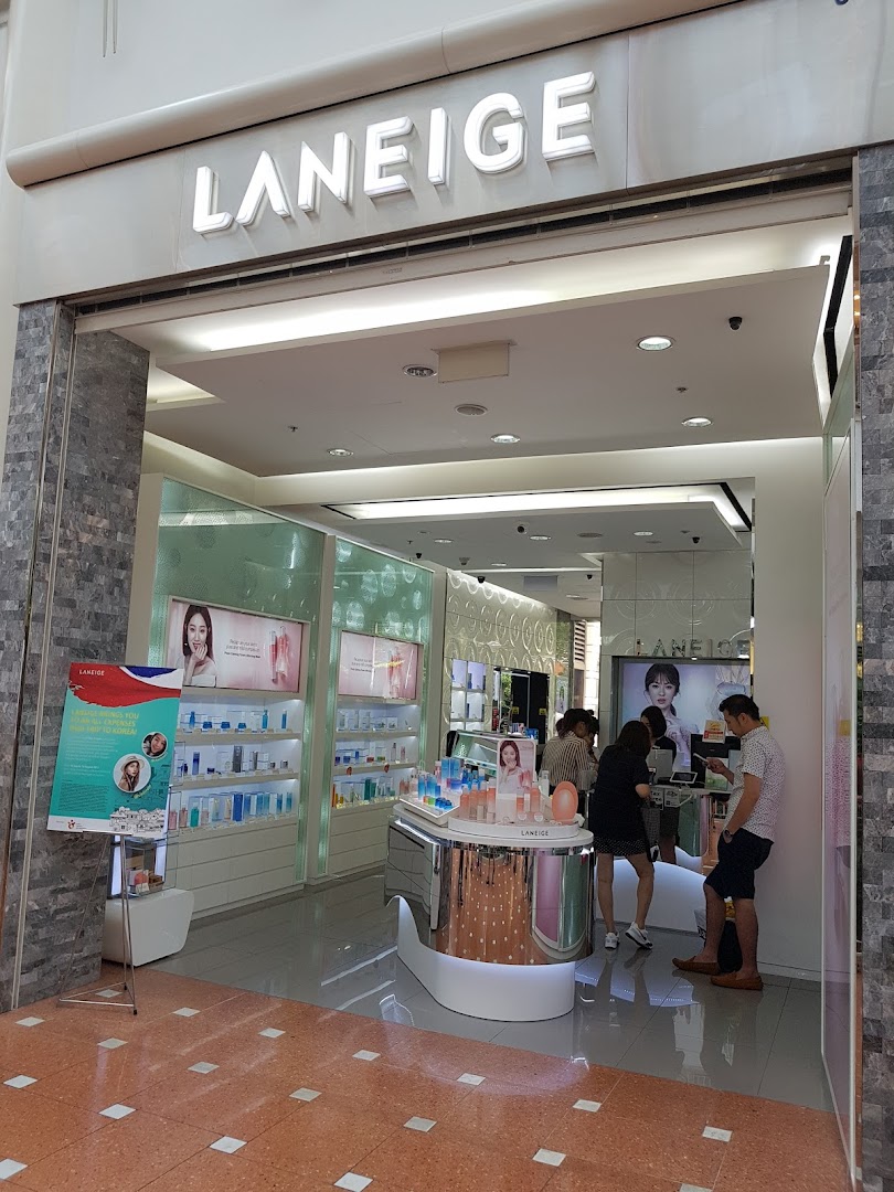 The inviting entrance of the LANEIGE beauty store, showcasing products and customers inside.