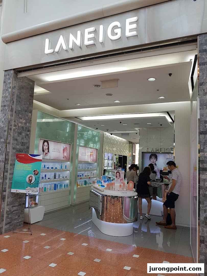 The inviting entrance of the LANEIGE beauty store, showcasing products and customers inside.