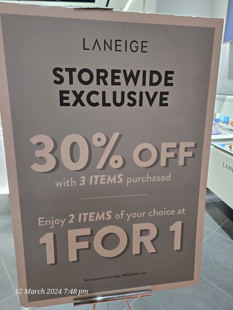 A promotional sign for LANEIGE displaying storewide exclusive offers including 30% off and 1-for-1 deals.