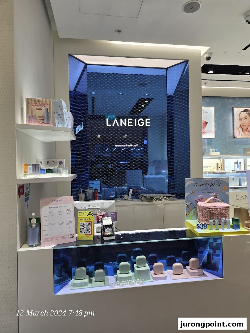 A brightly lit LANEIGE store counter showcasing skincare products, promotional displays, and payment options.