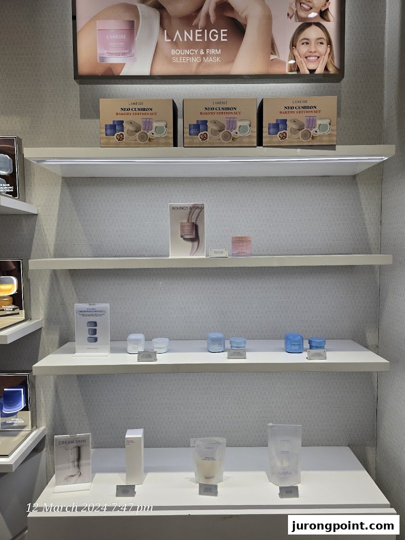 LANEIGE skincare products displayed on white shelves with promotional signage and product sets.