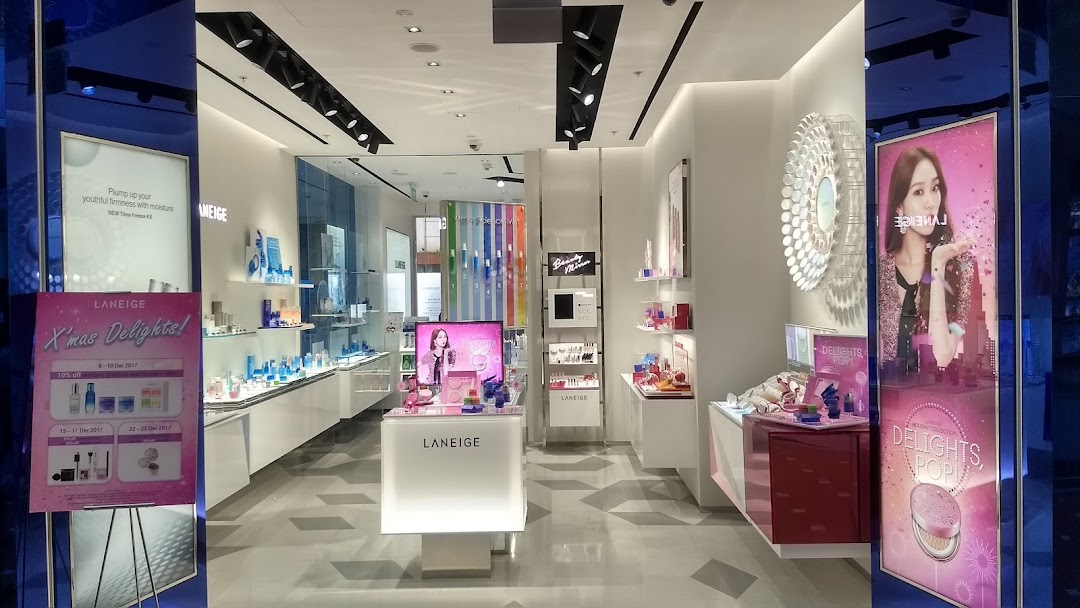 The brightly lit interior of a LANEIGE cosmetics store showcasing skincare and makeup products with promotional displays.