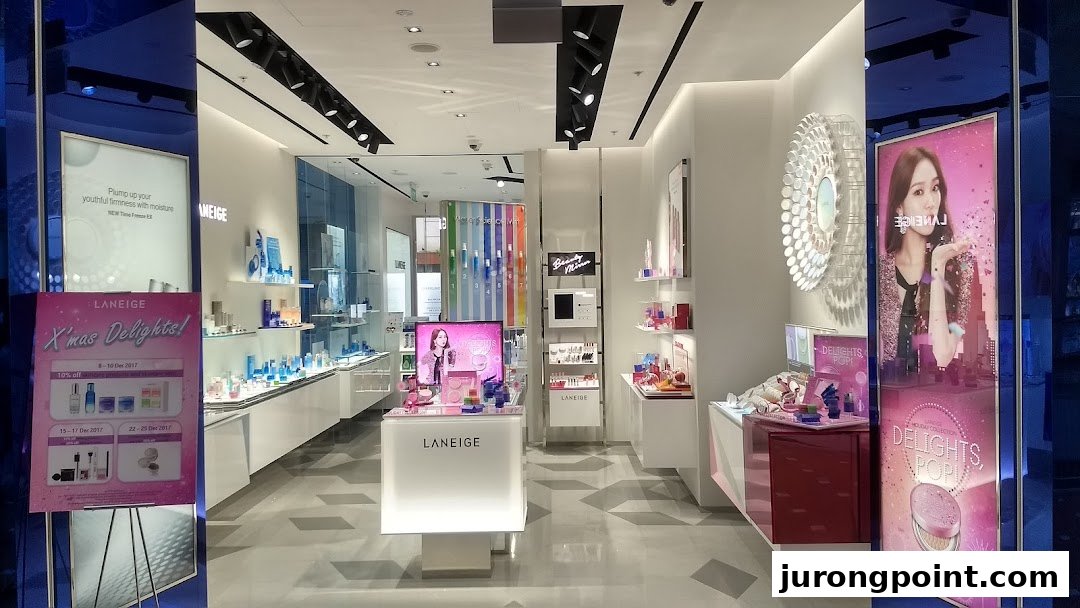 The brightly lit interior of a LANEIGE cosmetics store showcasing skincare and makeup products with promotional displays.