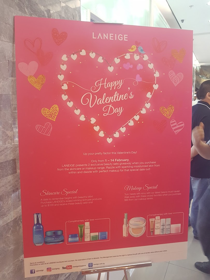 A vibrant pink promotional poster for Laneige, featuring Valentine's Day beauty specials and offers.