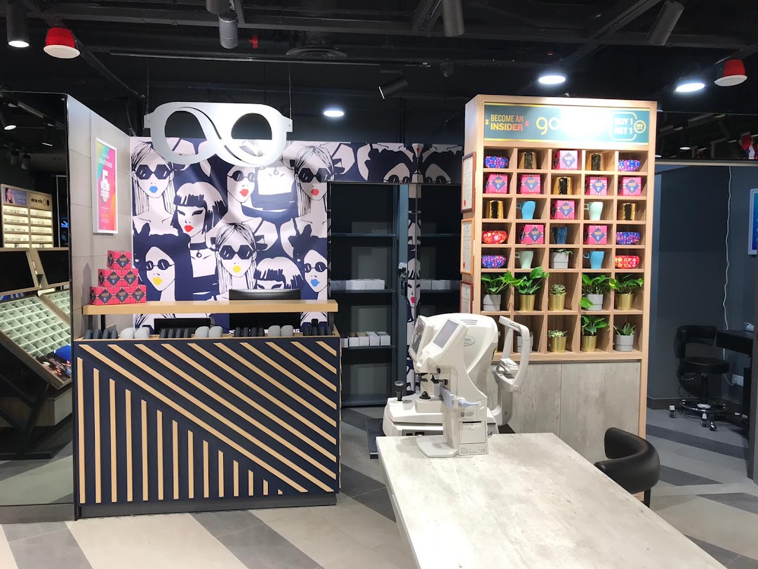 Interior view of Lenskart, showcasing stylish eyewear displays, eye examination equipment, and modern decor.
