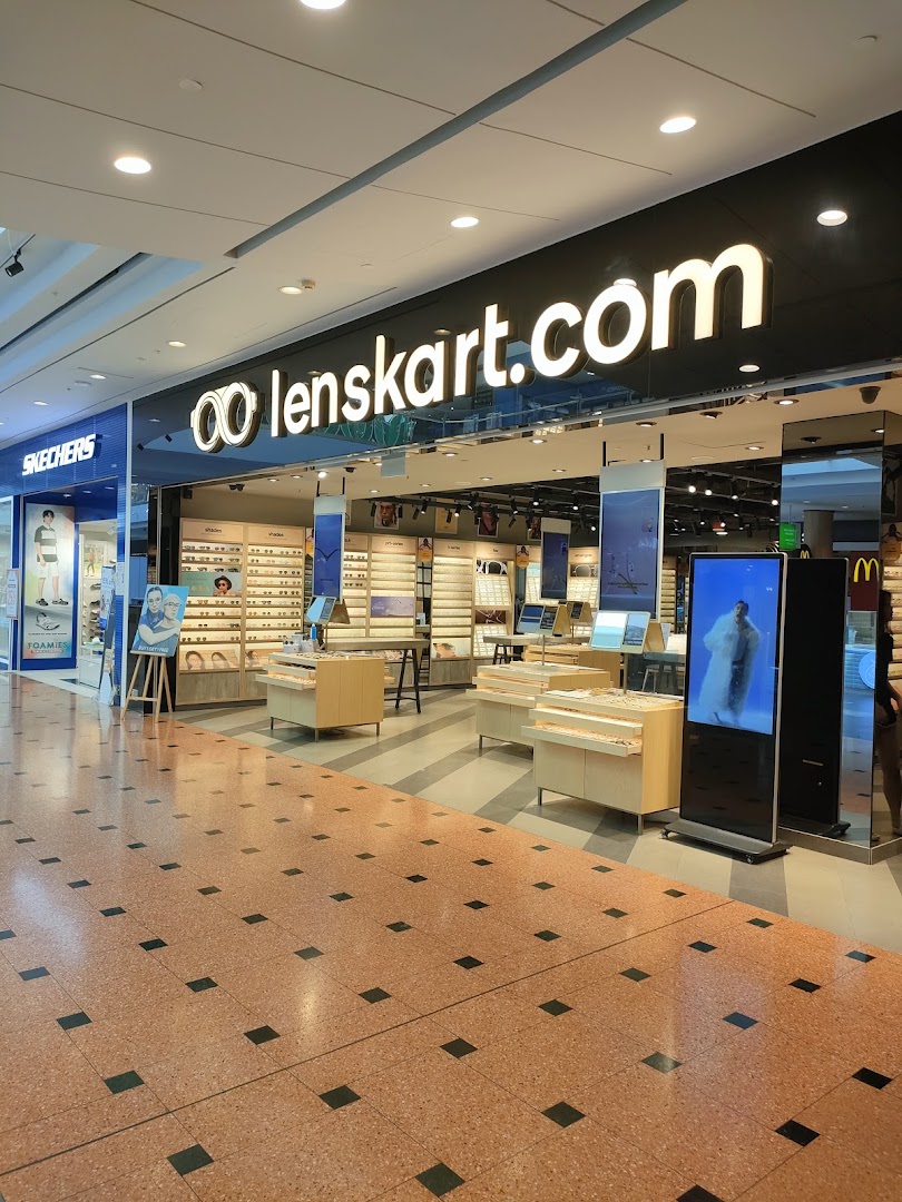 The Lenskart storefront in a mall, displaying a wide range of eyeglasses and a digital screen.
