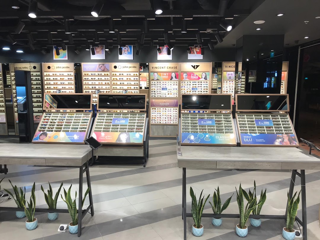 An interior view of Lenskart showcasing various eyewear displays, including glasses and sunglasses, with promotional signage.