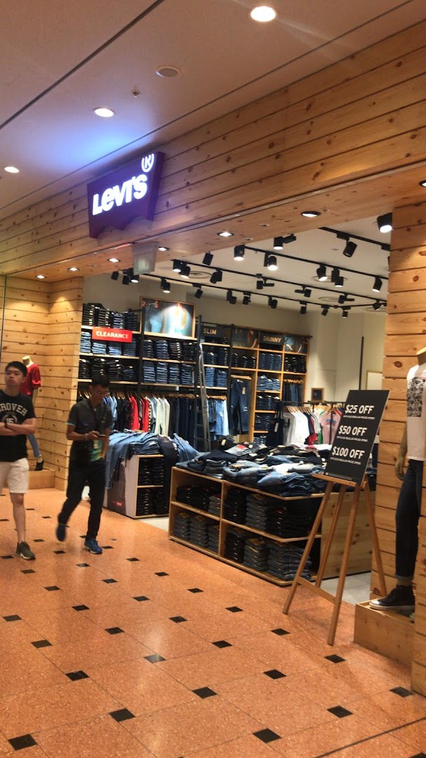 The Levi's store entrance features a prominent logo, wooden paneling, and displays of denim apparel.