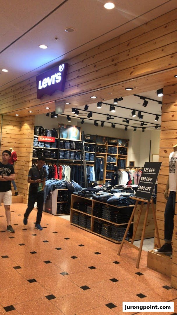 The Levi's store entrance features a prominent logo, wooden paneling, and displays of denim apparel.