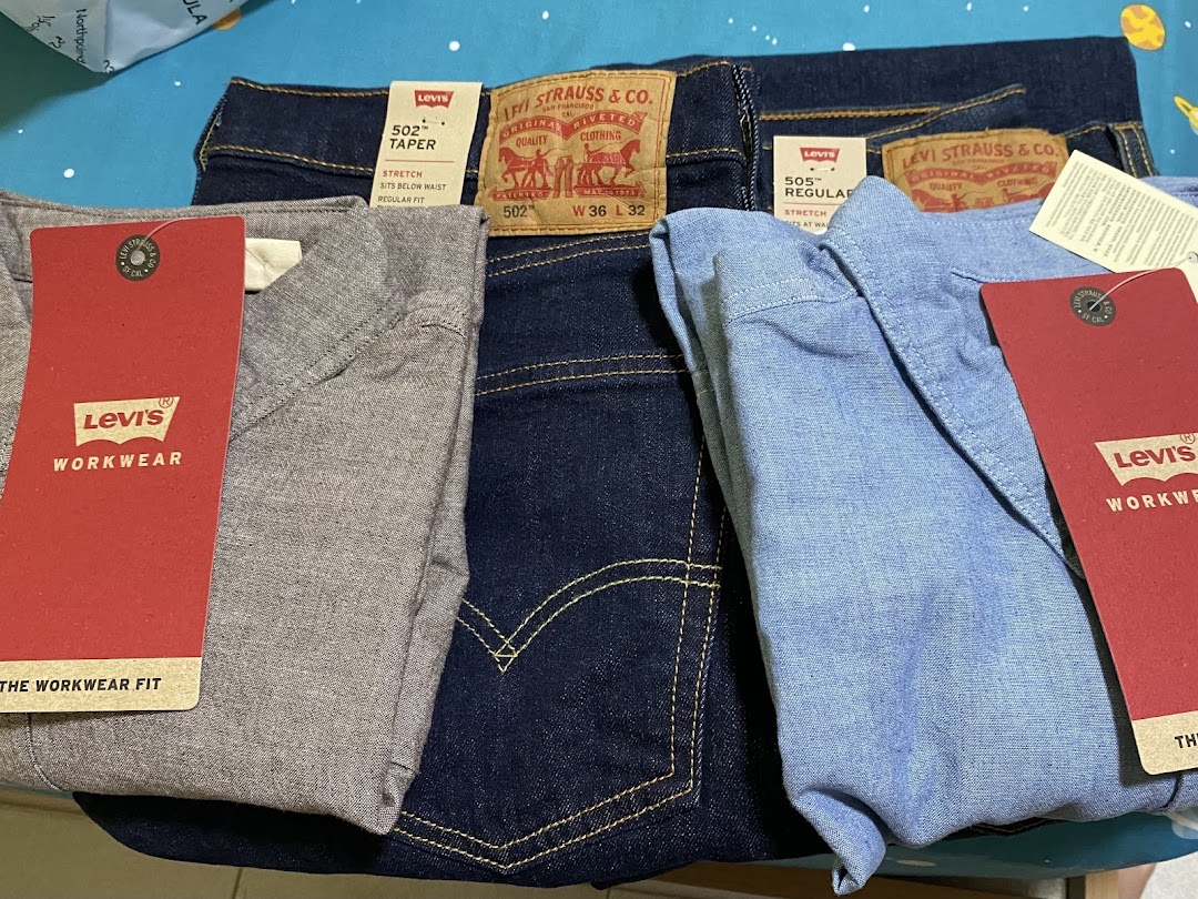 Close-up of various Levi's apparel, including jeans and shirts, with product tags visible.