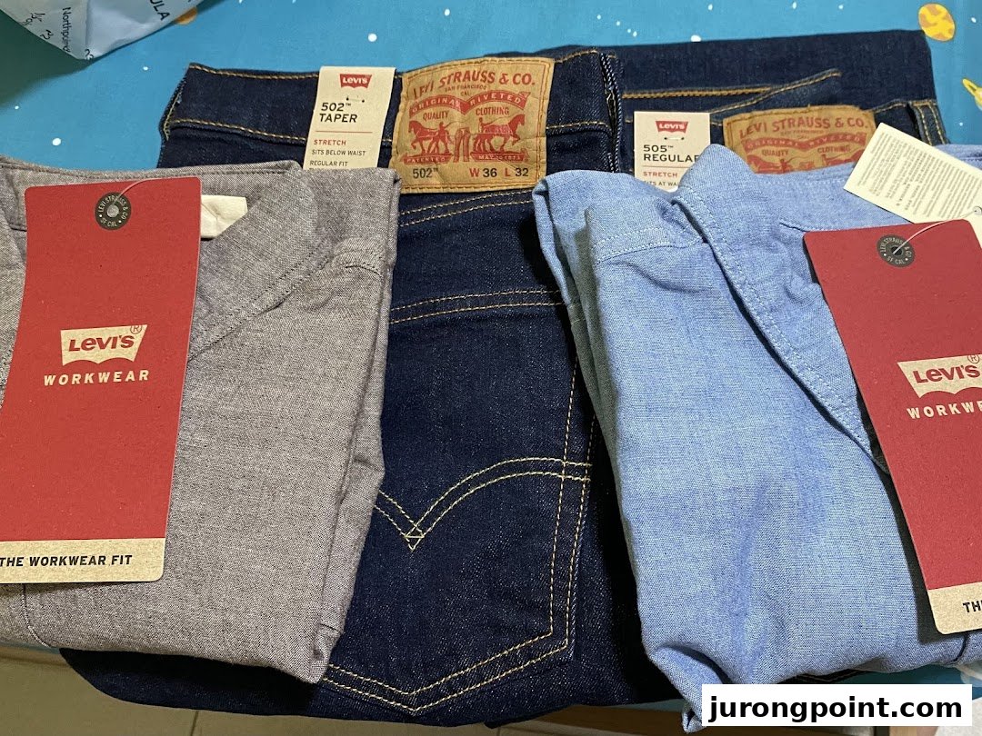 Close-up of various Levi's apparel, including jeans and shirts, with product tags visible.