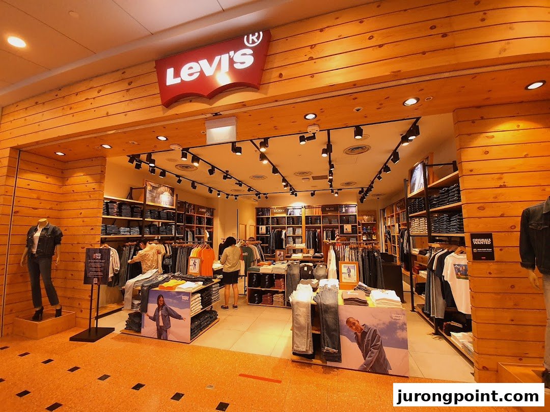 The entrance of a Levi's store with its iconic logo and a view of the denim and apparel inside.