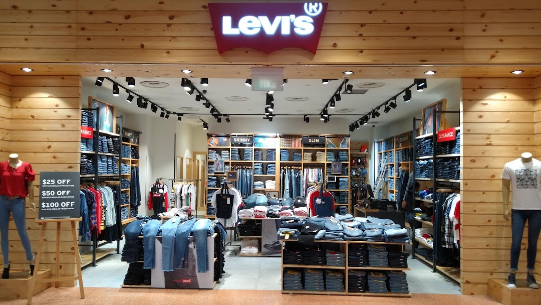 The image shows the well-lit entrance of a Levi's store with wooden paneling and denim displays.