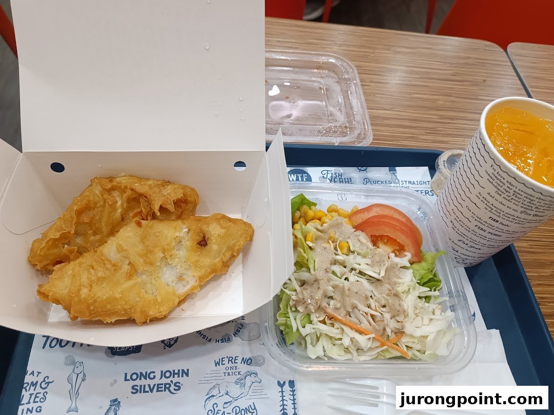 A delicious meal from Long John Silver's featuring fried fish, a fresh salad, and a refreshing drink.