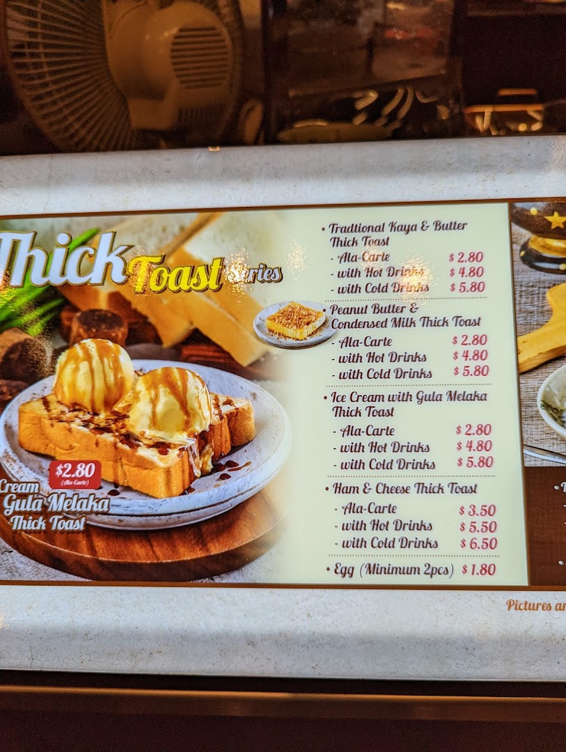 A vibrant menu board showcasing various thick toast options with prices and accompanying drinks.