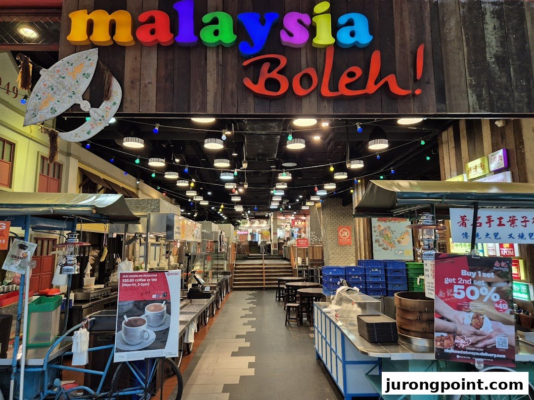 The vibrant entrance to Malaysia Boleh! food court, showcasing diverse Malaysian street food stalls.