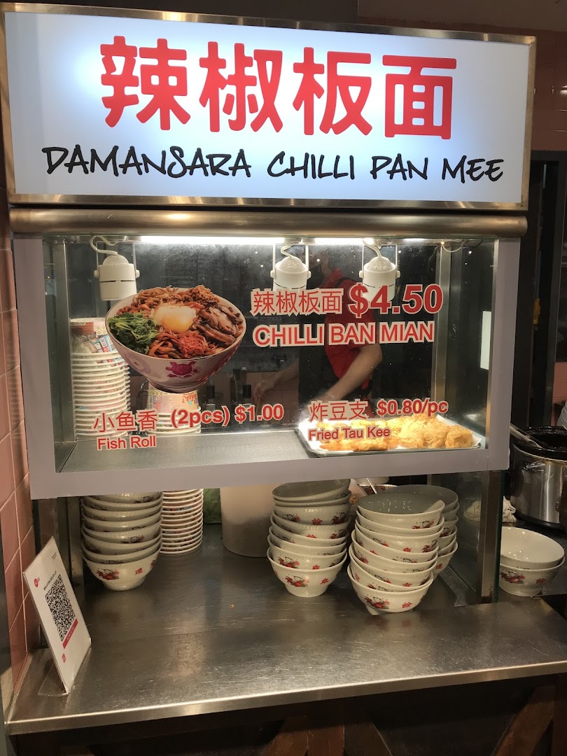 A food stall display featuring Damansara Chilli Pan Mee with prices for noodles and side dishes.