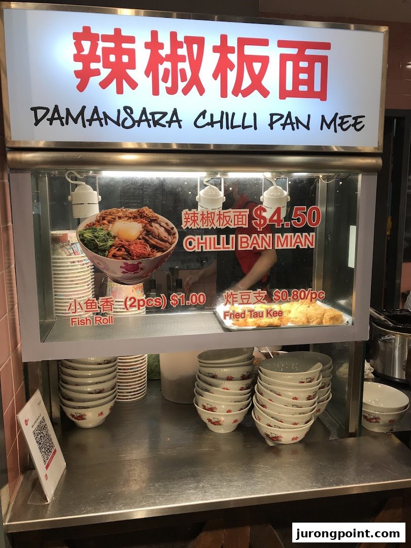 A food stall display featuring Damansara Chilli Pan Mee with prices for noodles and side dishes.