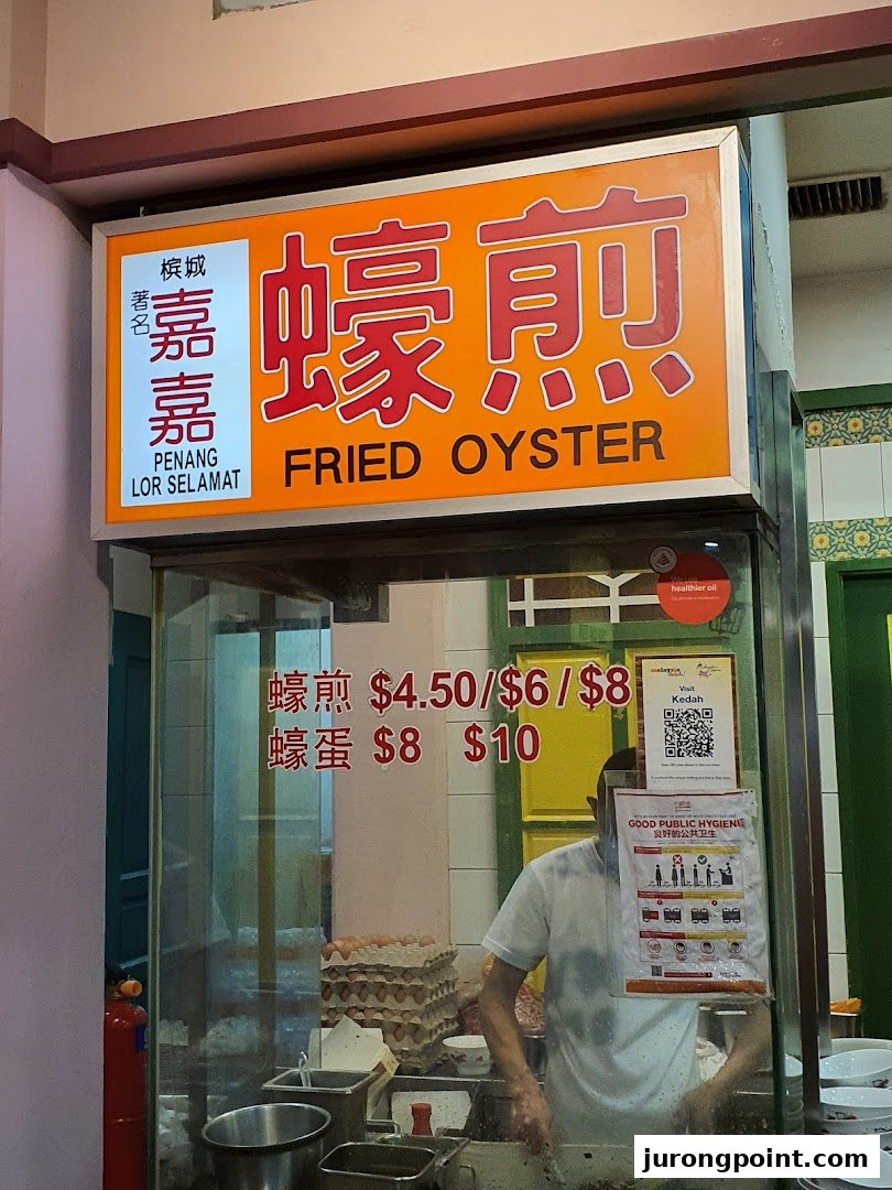 A food stall sign for 'Fried Oyster' with prices and a chef preparing dishes.