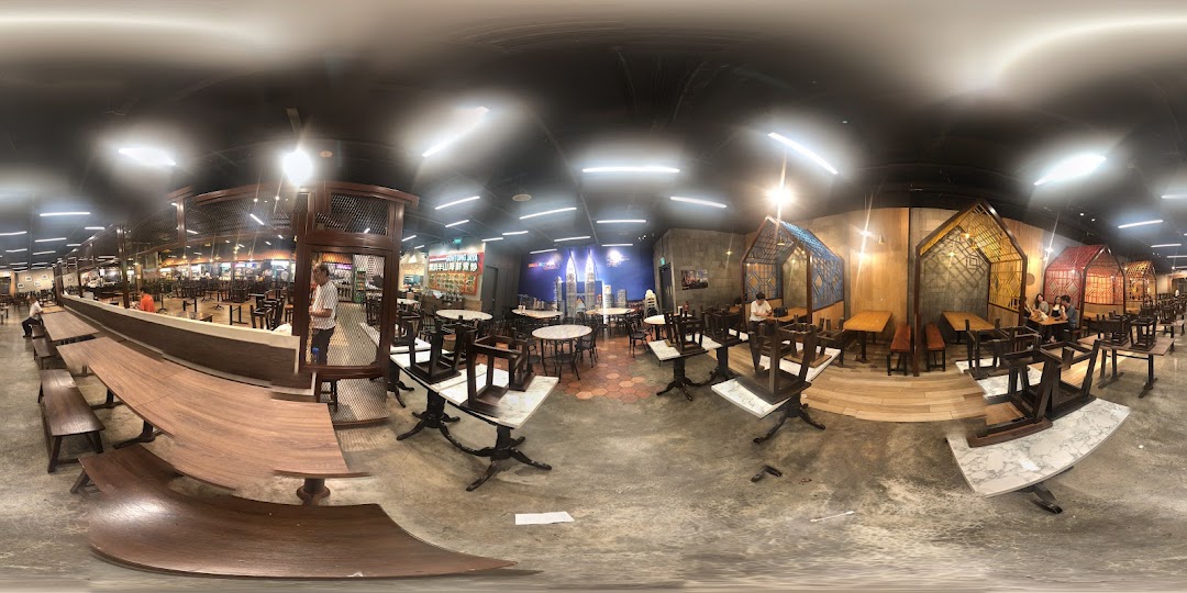 A panoramic view of a spacious food court or restaurant interior with various seating arrangements and modern design.
