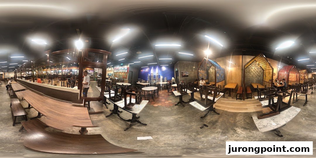 A panoramic view of a spacious food court or restaurant interior with various seating arrangements and modern design.