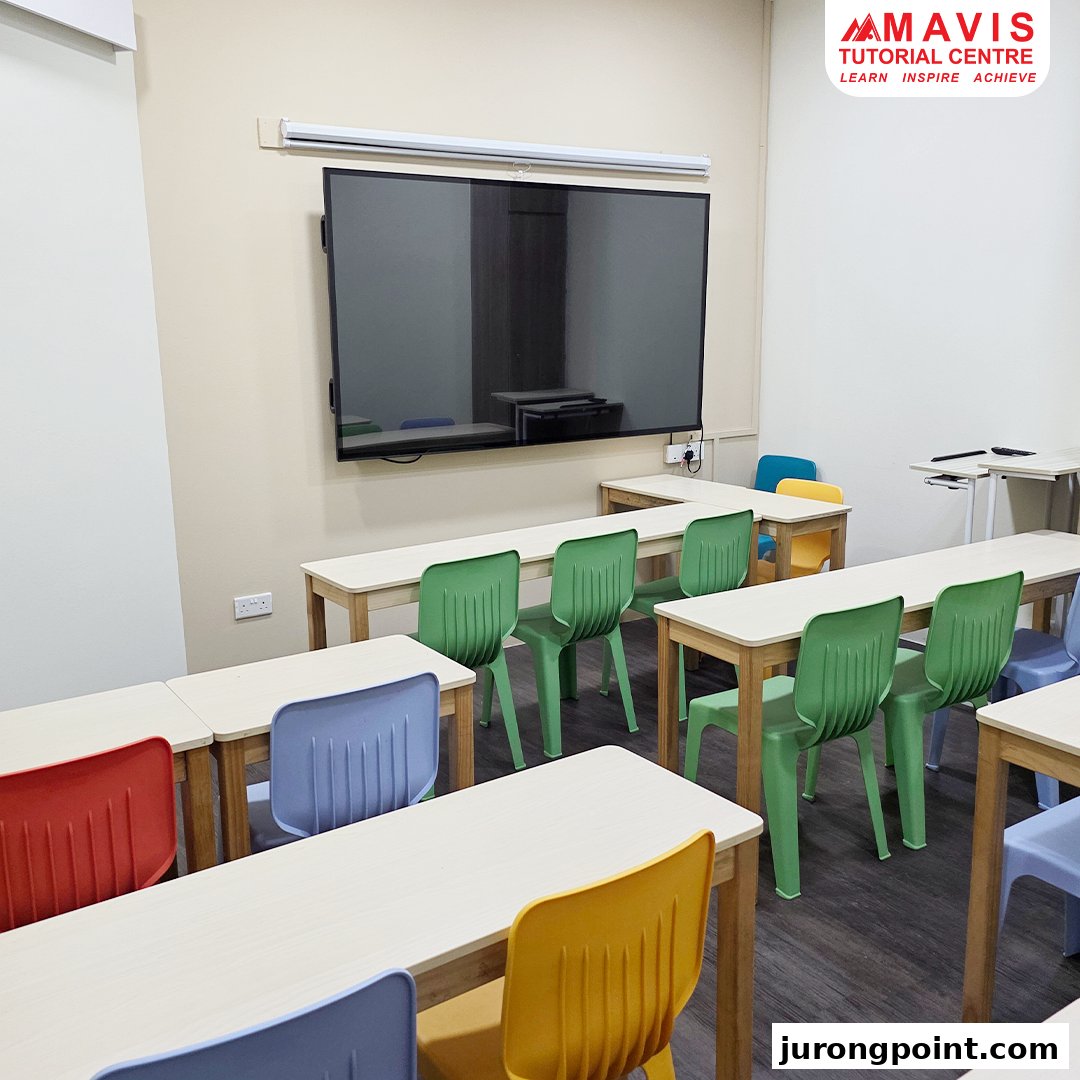 A modern classroom at Mavis Tutorial Centre with colorful chairs, desks, and a large interactive screen.