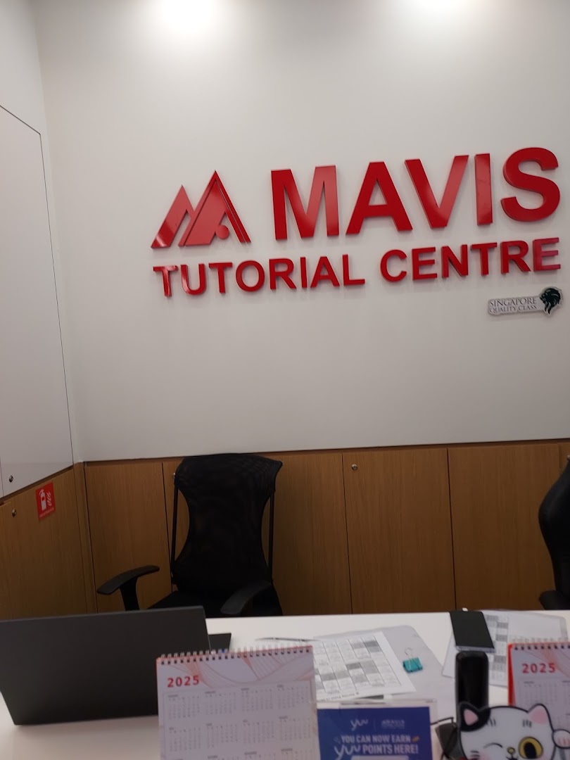 Interior view of Mavis Tutorial Centre's reception area featuring the prominent red logo.
