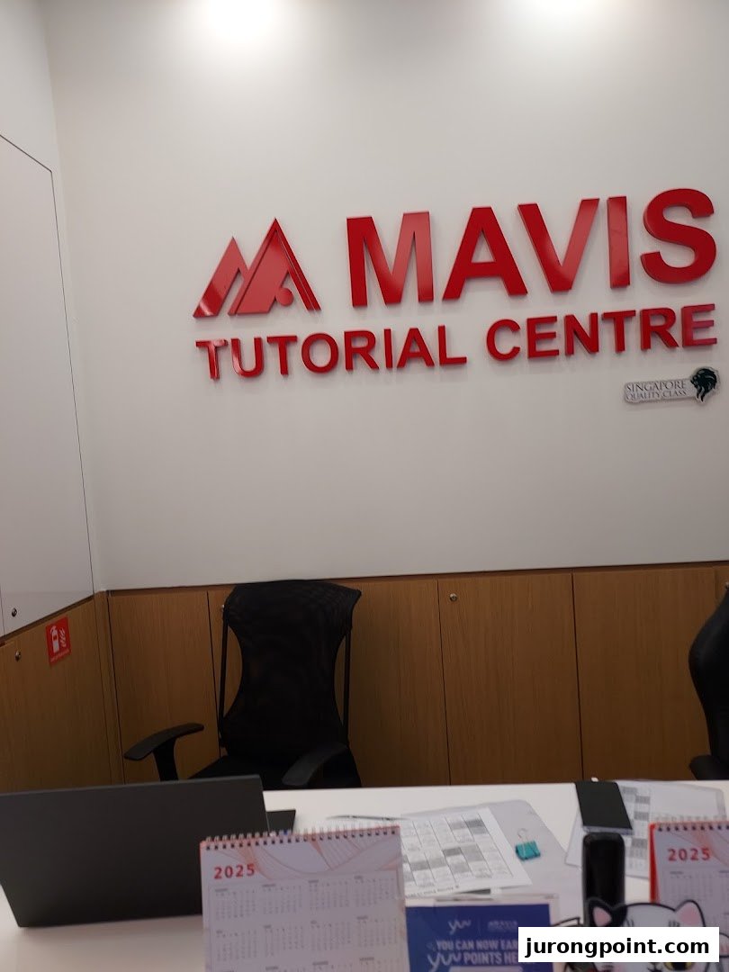 Interior view of Mavis Tutorial Centre's reception area featuring the prominent red logo.