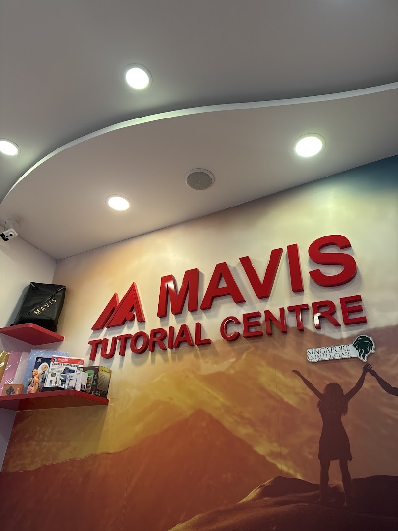 Interior wall of Mavis Tutorial Centre featuring its prominent red 3D logo and a motivational mural.
