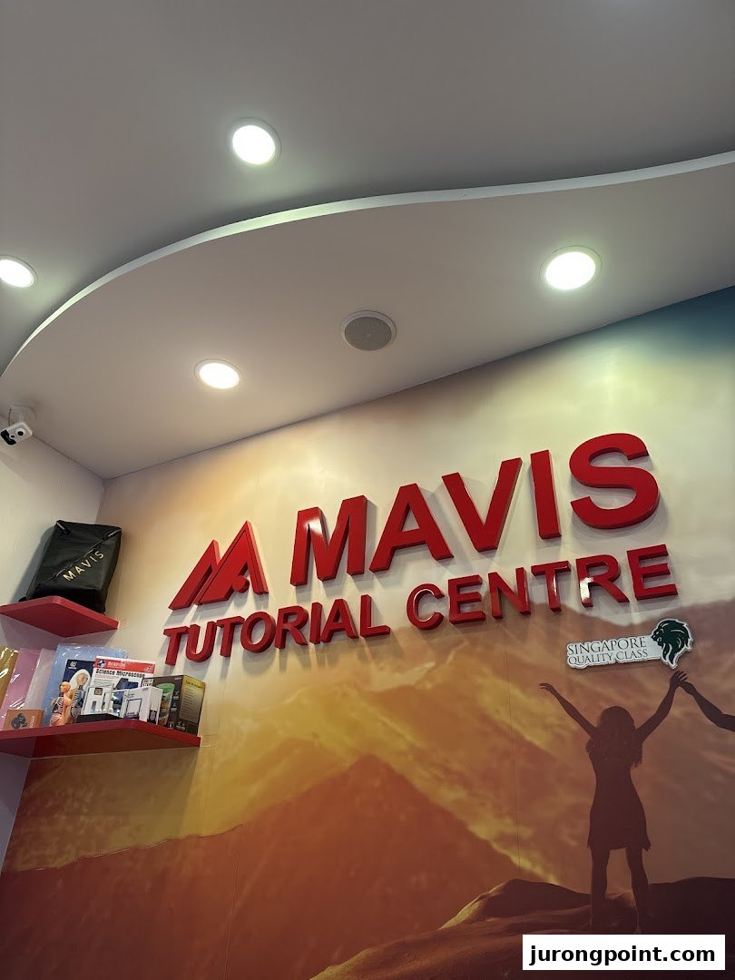 Interior wall of Mavis Tutorial Centre featuring its prominent red 3D logo and a motivational mural.