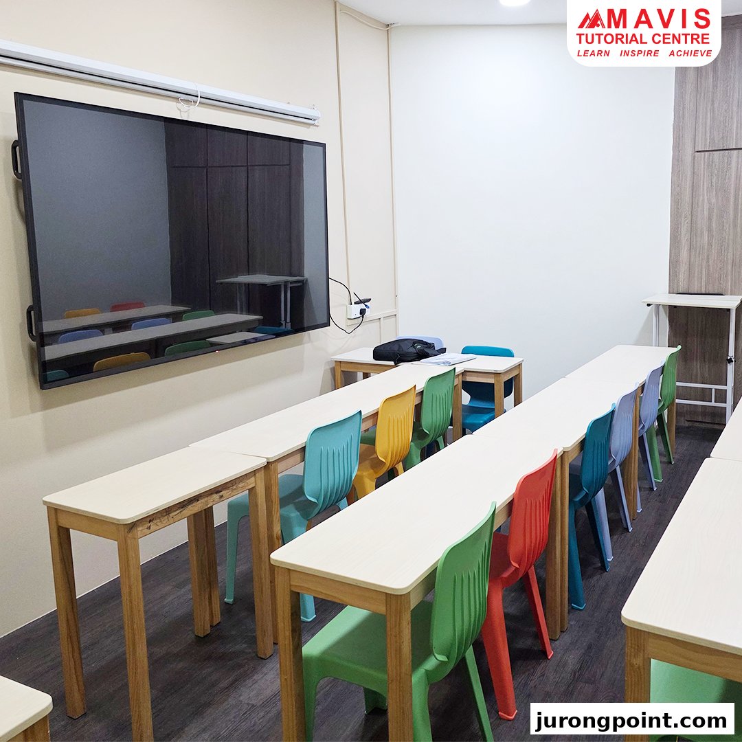 A modern classroom at Mavis Tutorial Centre with colorful chairs and a large display screen.