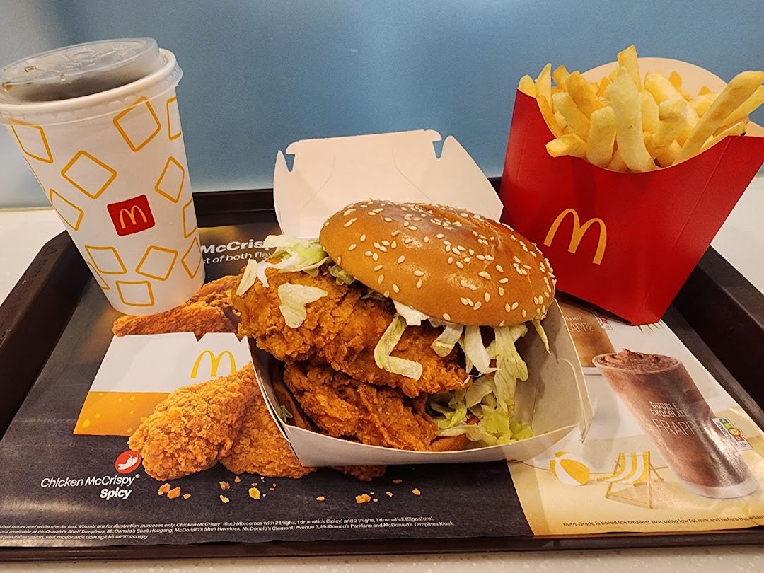 A McDonald's meal featuring a crispy chicken burger, fries, and a drink on a tray.