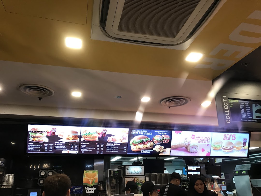 Digital menu boards at McDonald's displaying various food items, prices, and promotions.