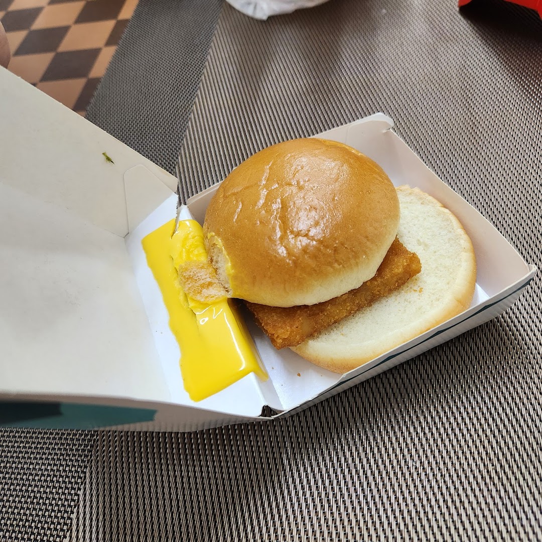 A McDonald's Filet-O-Fish sandwich with melted cheese in its open box.