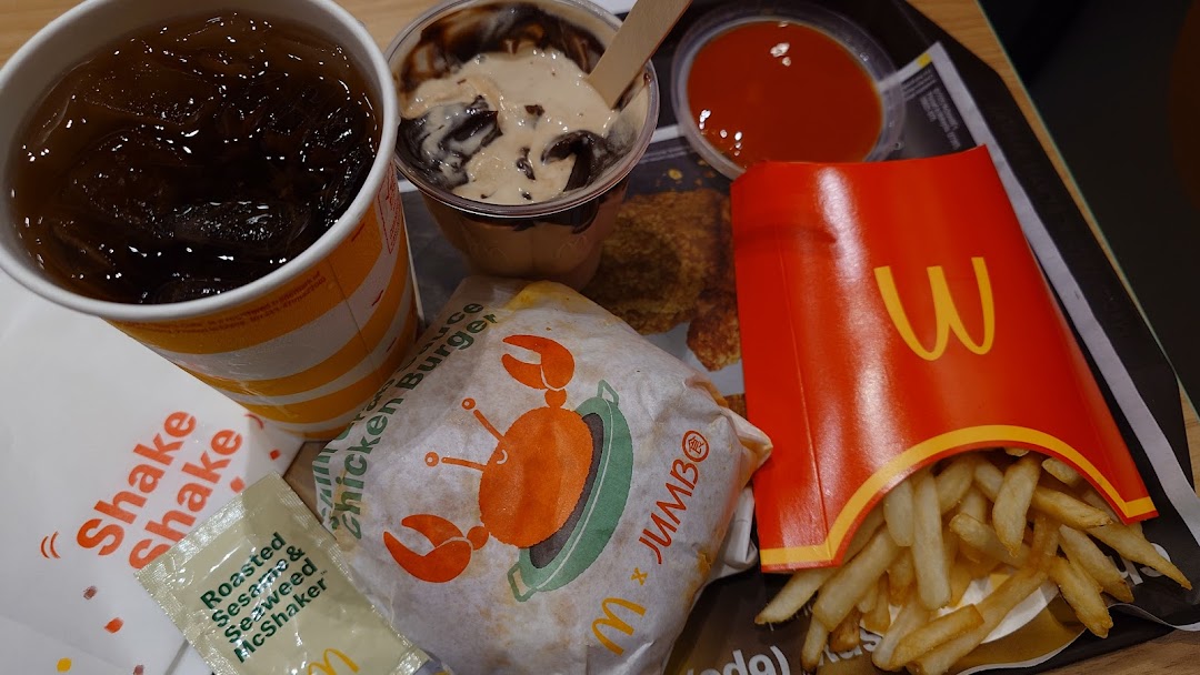 A tray of McDonald's food including a drink, fries, a burger, and a dessert.