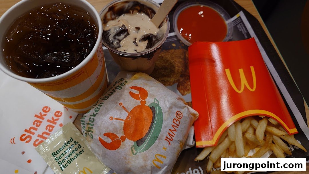 A tray of McDonald's food including a drink, fries, a burger, and a dessert.