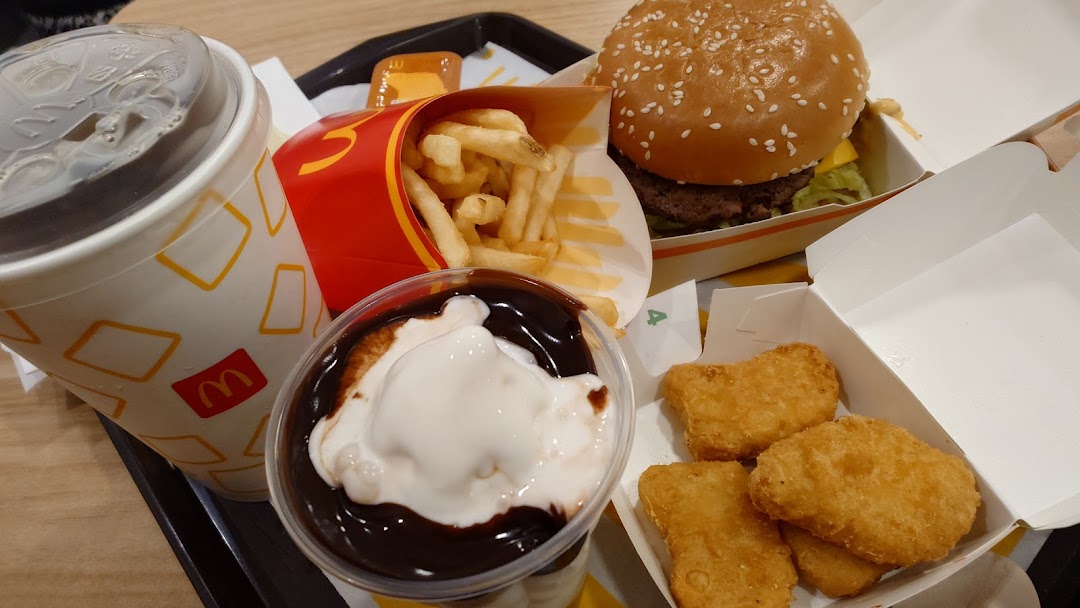 A close-up of a classic McDonald's meal featuring a burger, fries, drink, nuggets, and sundae.