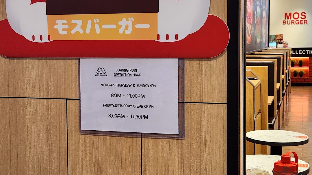 The entrance of MOS Burger at Jurong Point, displaying its operating hours.