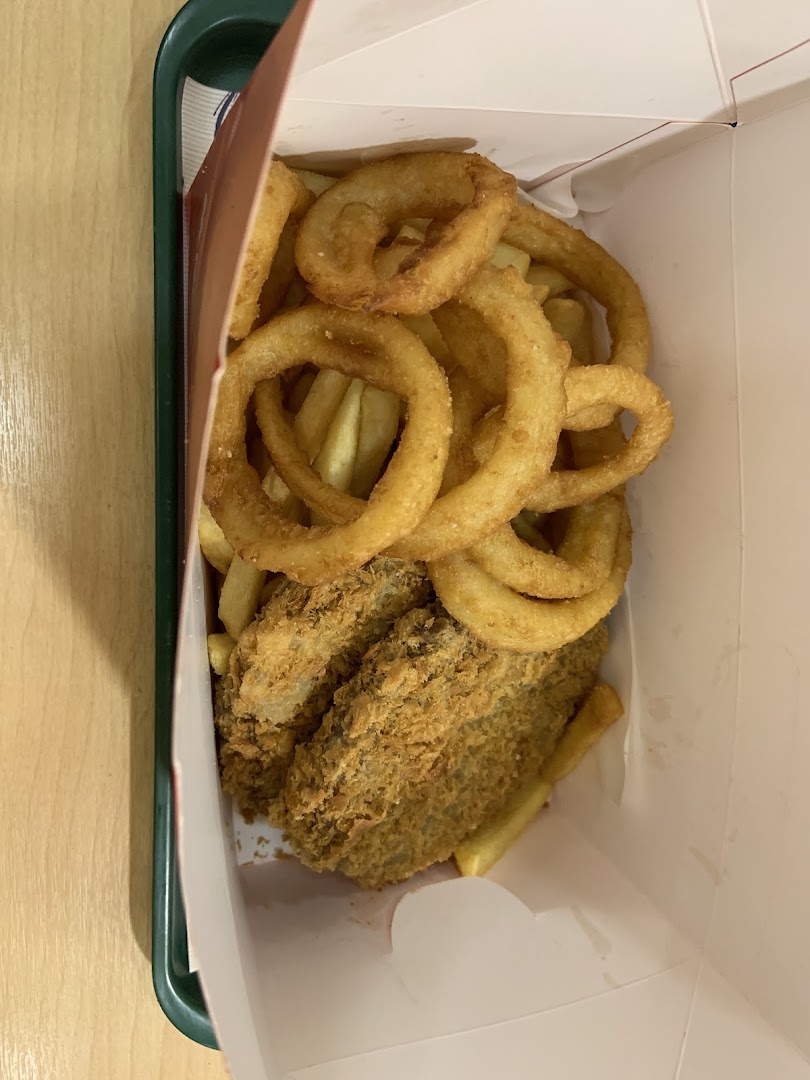 A box filled with golden fried onion rings, crispy fries, and breaded fish or chicken pieces.